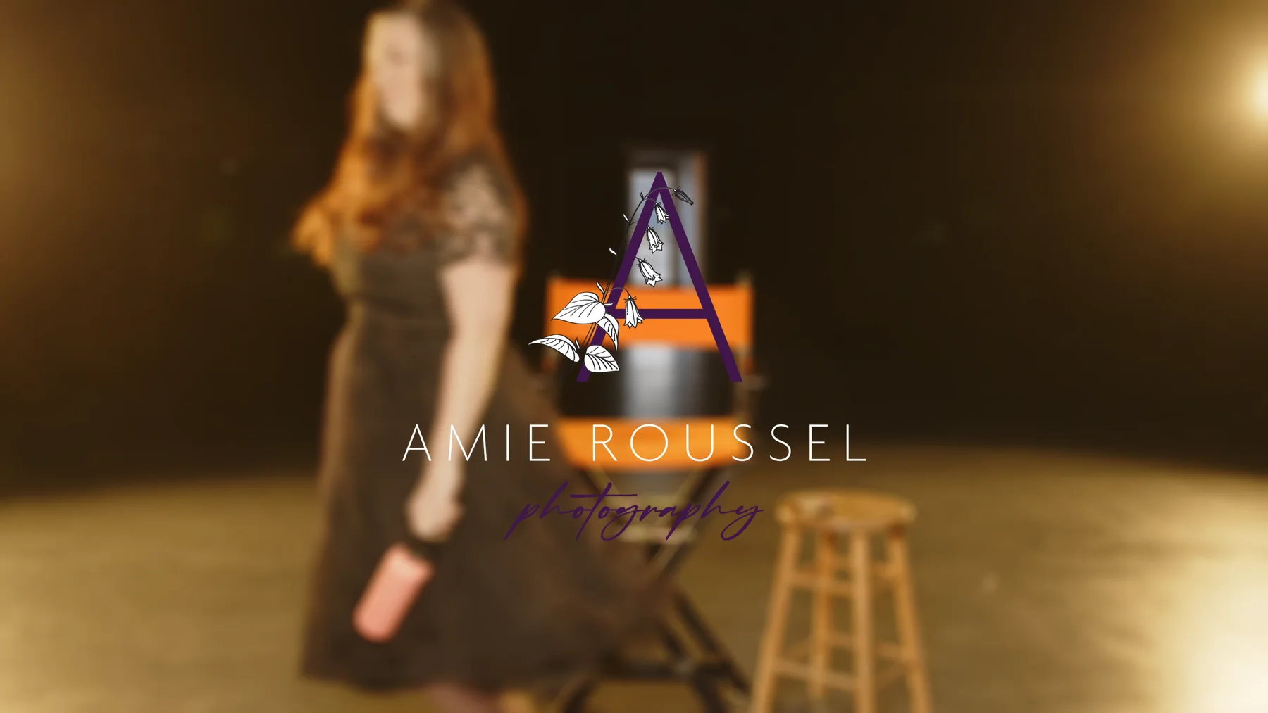 Outdoor family-session frame from the Amie Roussel Photography brand video.