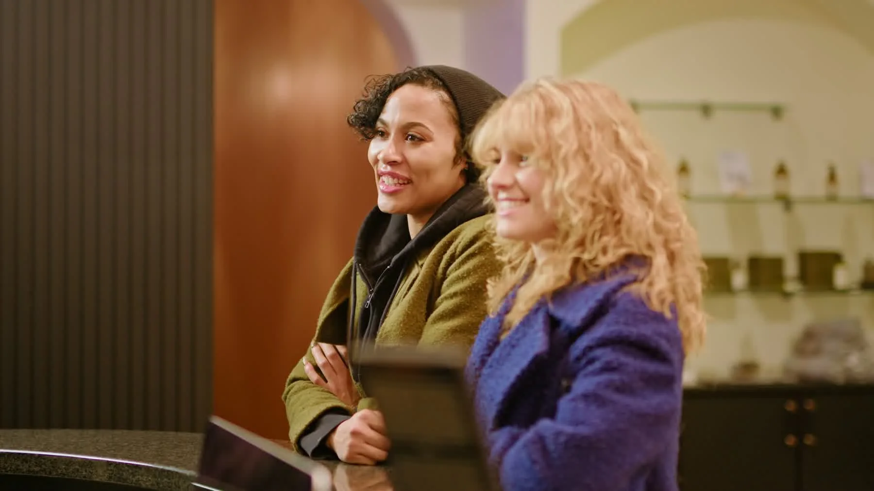 Two guests smiling at reception inside Cleopatra's Rituals in the finished launch video.