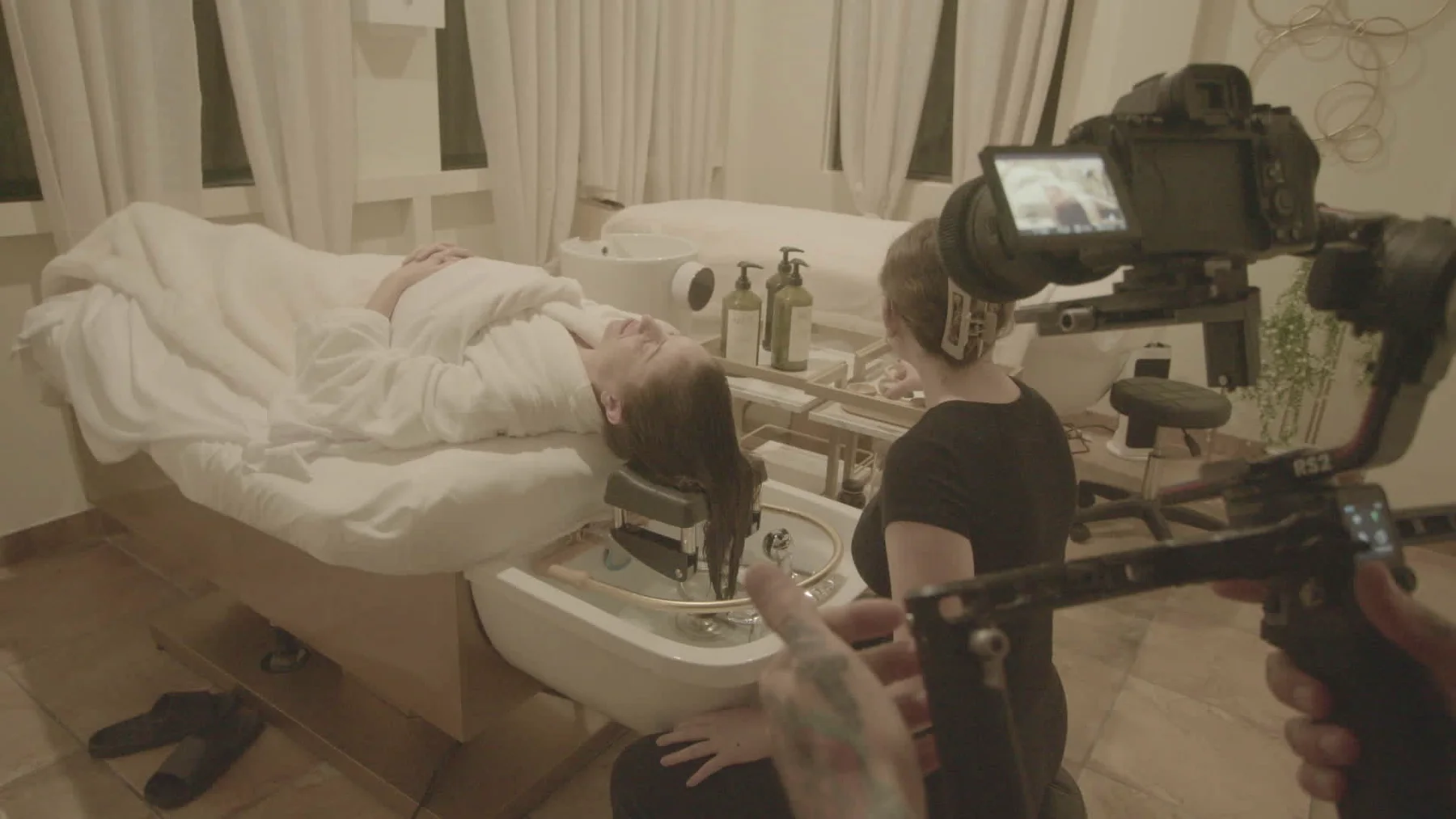 Camera and actor setup during scalp spa filming for Cleopatra's Rituals.