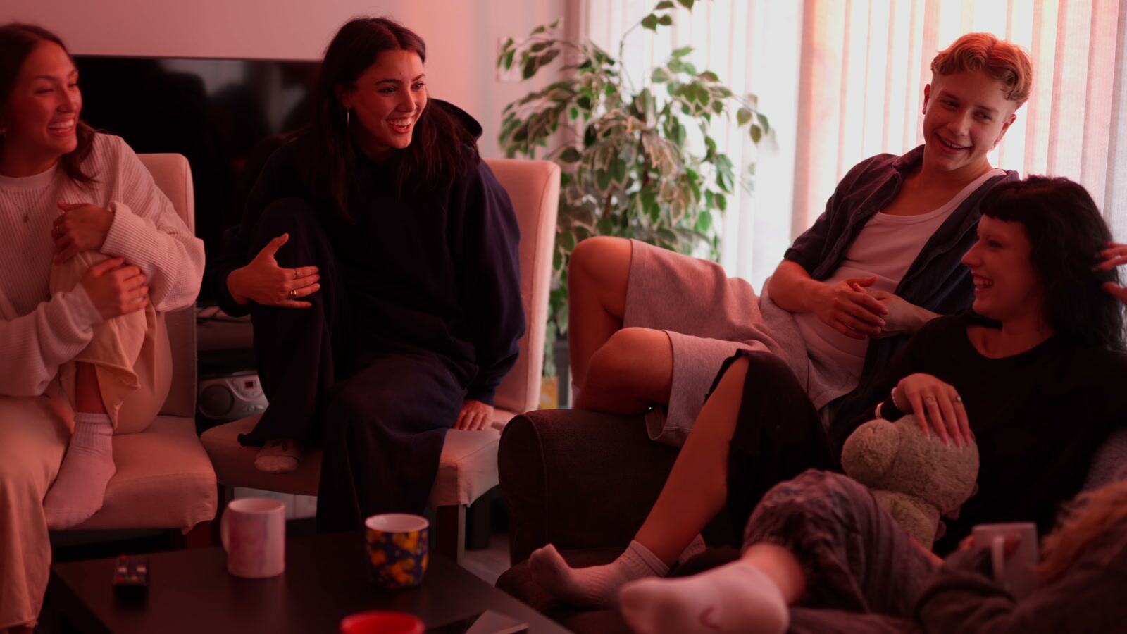 The friend group sharing a bright moment in a warm interior.