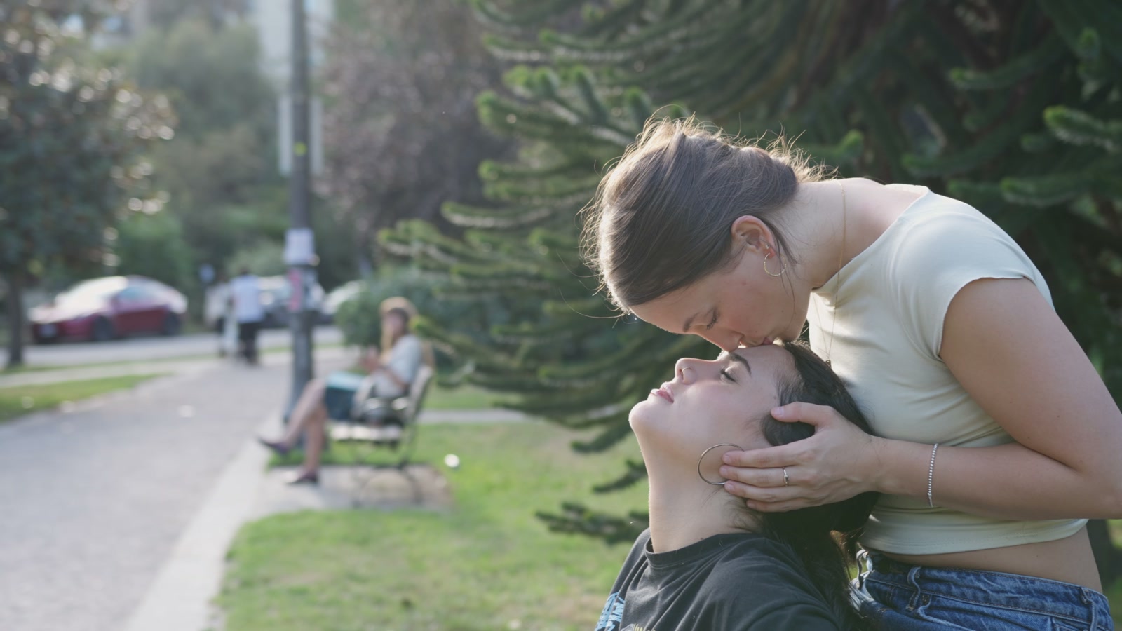 A tender outdoor moment between the two leads in Jamie.