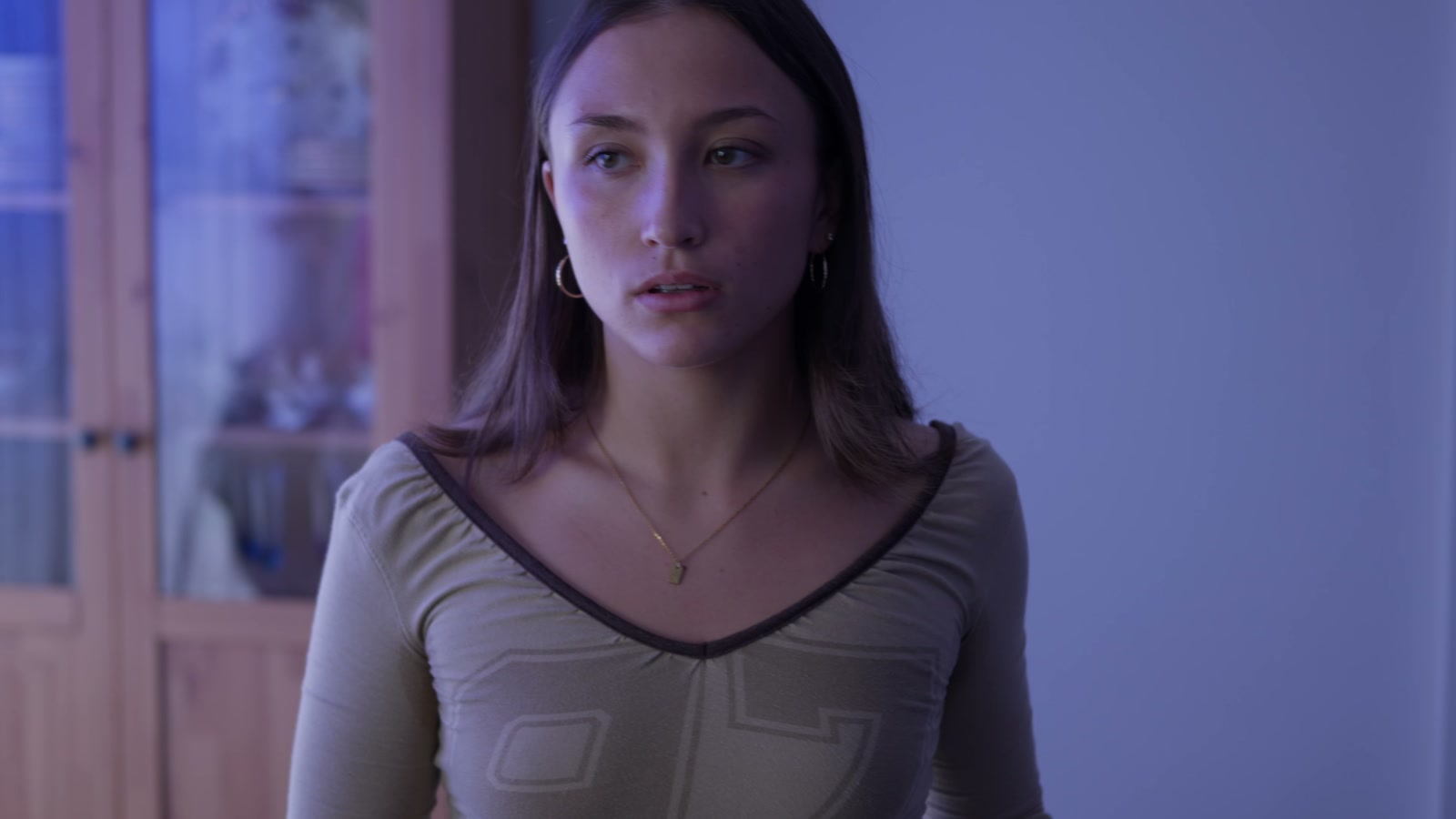 A close performance frame in a cool-toned room.