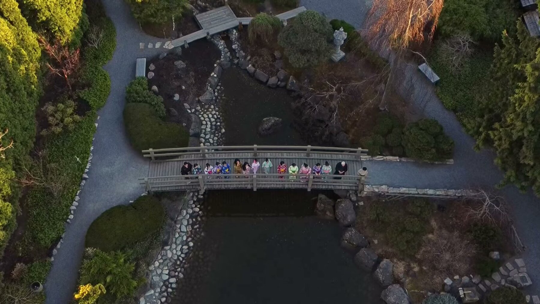 An aerial view of delegates gathered on a bridge in Kasugai Gardens, Kelowna.