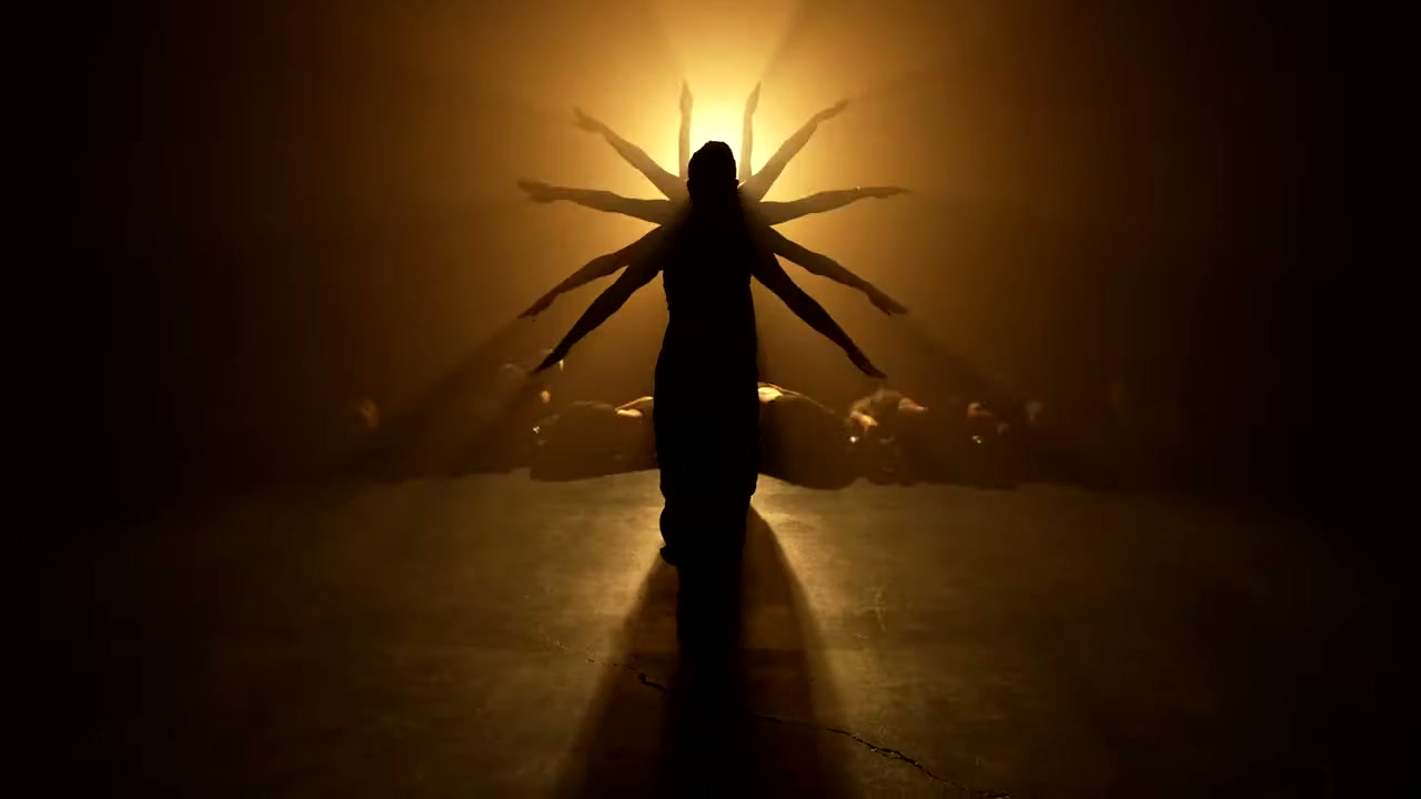 A dancer silhouetted against warm backlight in Sockeye.