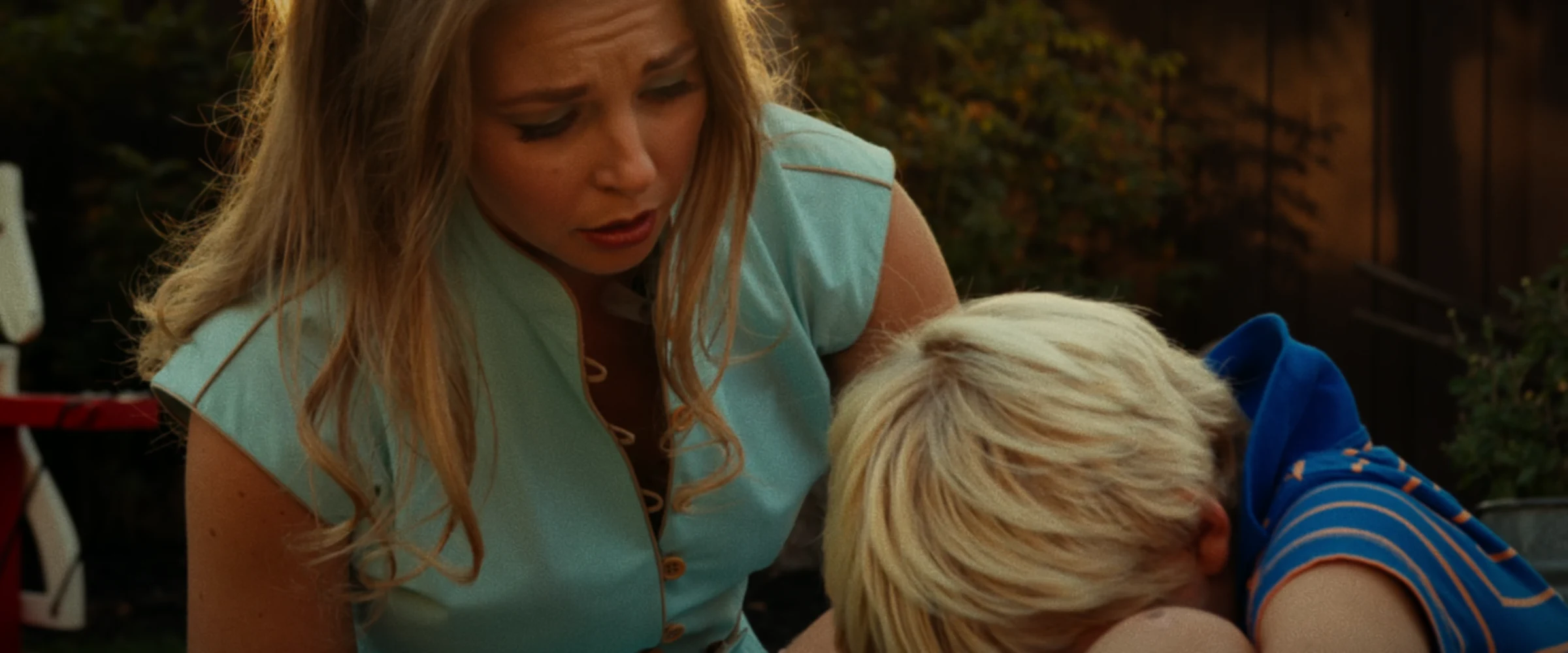 1960s Connie comforts young Dave in the yard in a finished frame from Three Hearts.